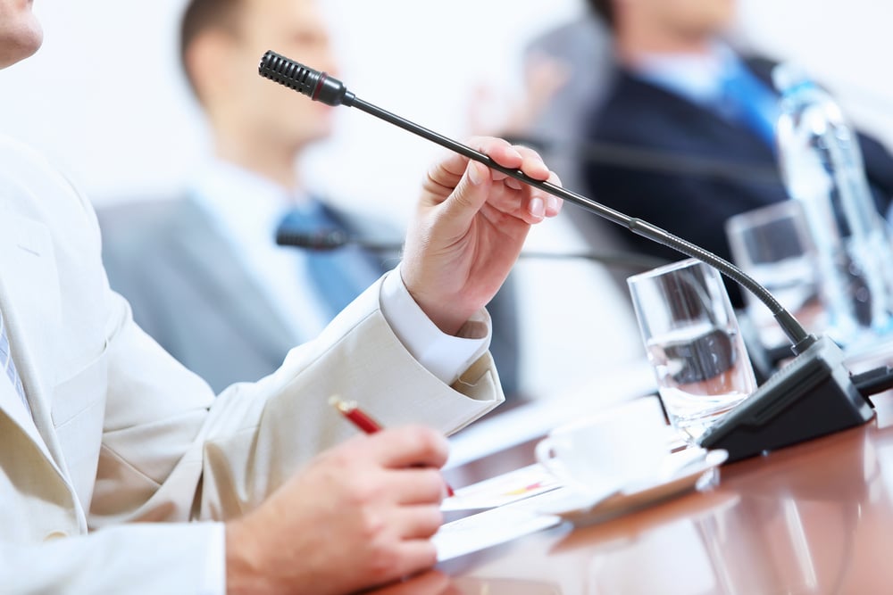 Image of businessmans hands holding microphone at conference-1