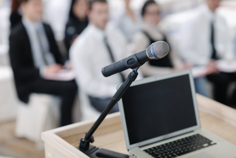 business laptop and microphotone at podium on seminar conference education-1