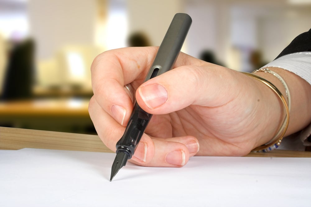 letter signature with an office background